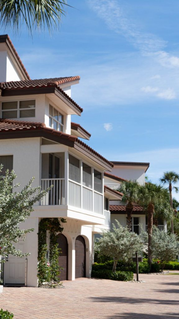 Beautiful beachfront home in Florida City with lush palm trees and clear skies.